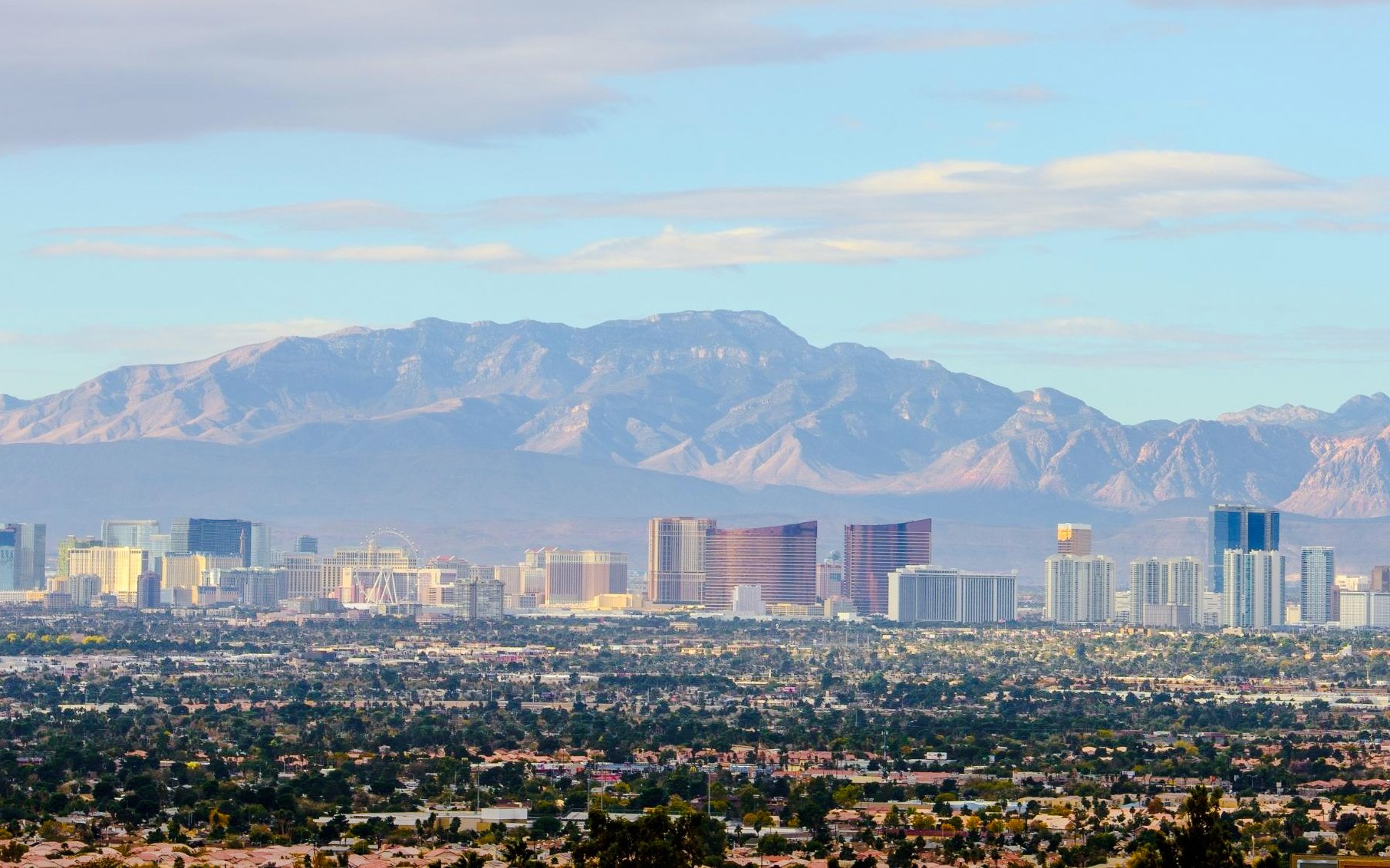 Las Vegas Valley skyline with mountains at dusk.