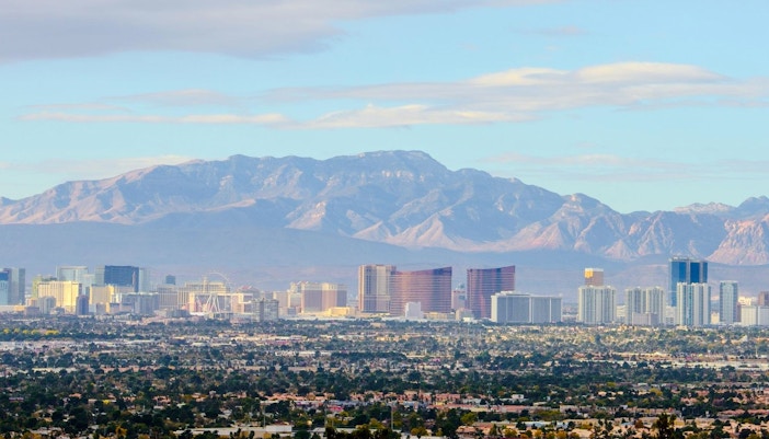 Las Vegas Valley skyline with mountains at dusk.