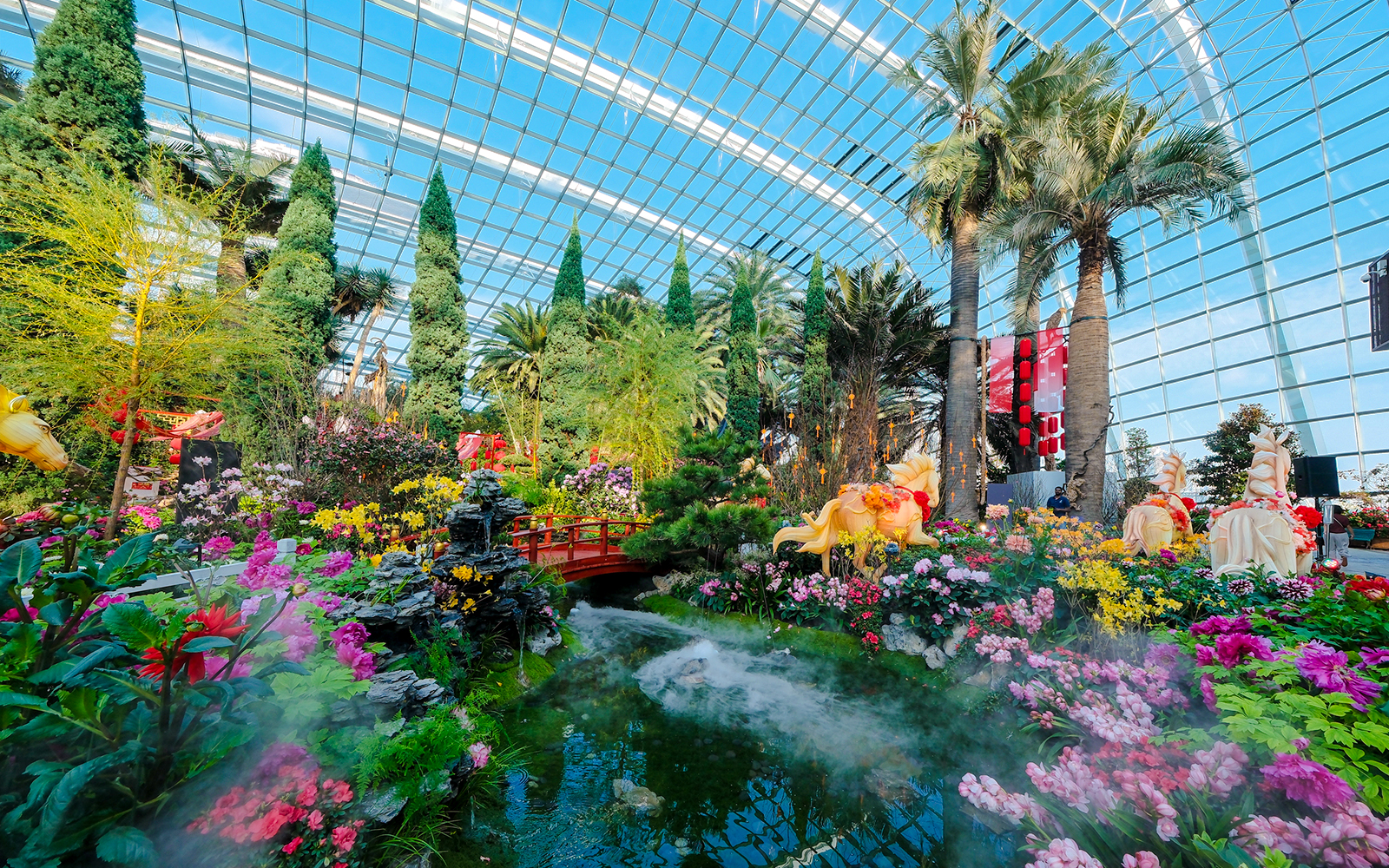 Spring blossoms in Flower Dome, Gardens by the Bay, Singapore with vibrant flowers and lush greenery.