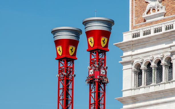 Thrill Towers ride at Ferrari Land with people ascending in red towers.