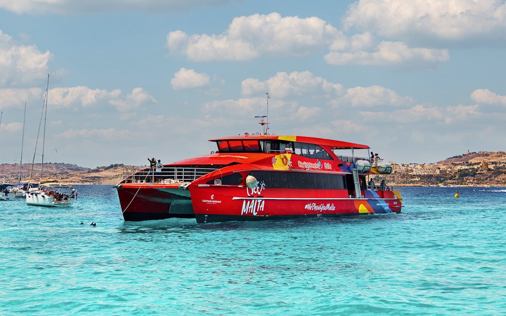 Red cruise boat on Gozo and Comino Blue Lagoon trip, Malta.