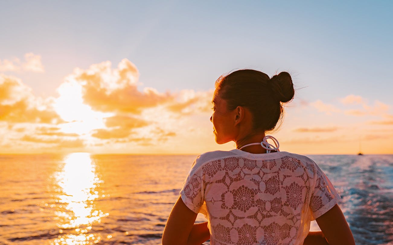 Woman enjoying sunset on Athens sightseeing cruise.