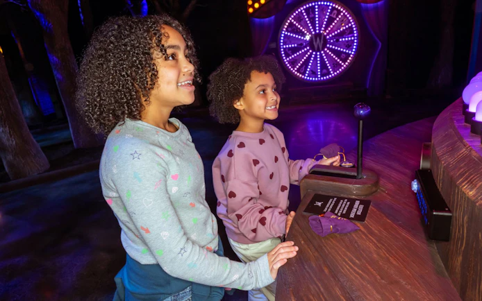 Children enjoying interactive exhibit at Netflix House, Wednesday play set, Philadelphia.