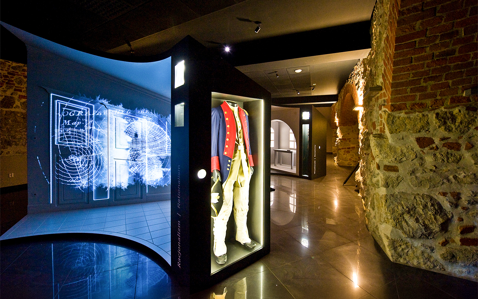 Exhibit of historical military uniform and digital map display inside Kościuszko Mound, Krakow.