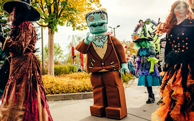 Lego Frankenstein and costumed visitors at Halloween event in Legoland Billund.