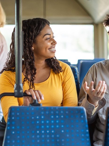 People chatting inside Aerobus traveling to Barcelona city center.