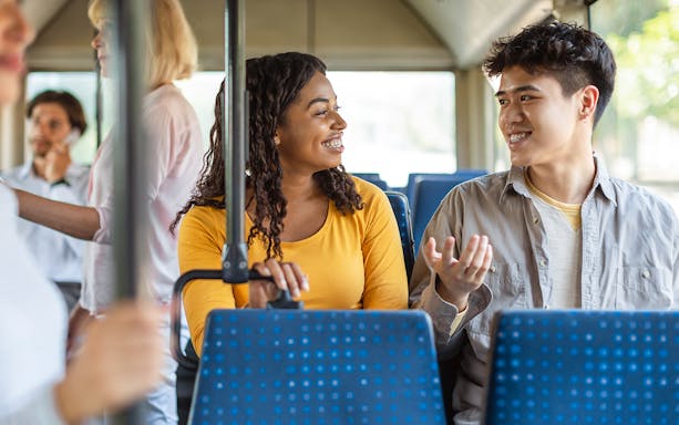 People chatting inside Aerobus traveling to Barcelona city center.