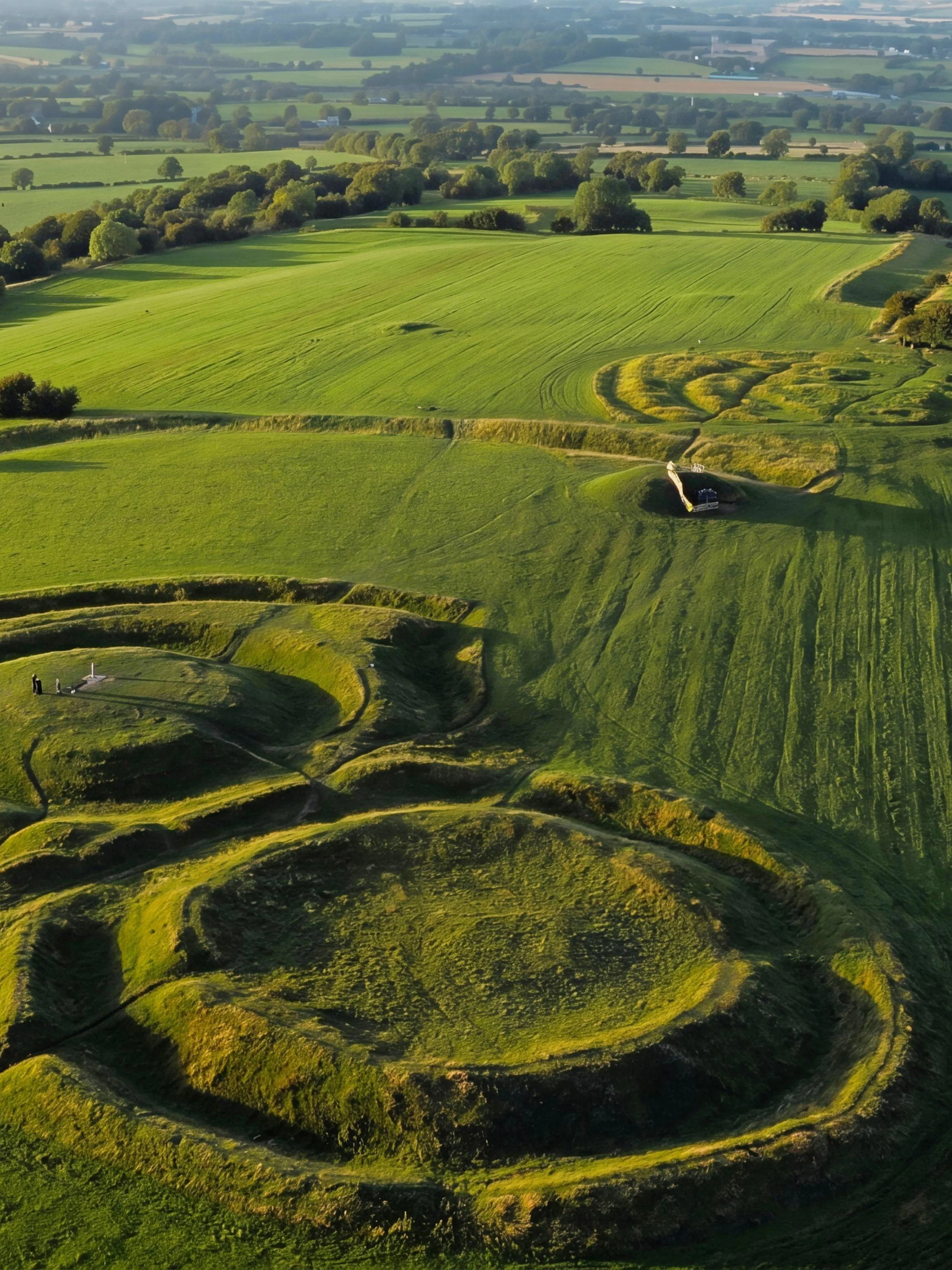 Aerial view of the Hill of Tara, Ireland, featuring ancient earthworks and lush green fields.