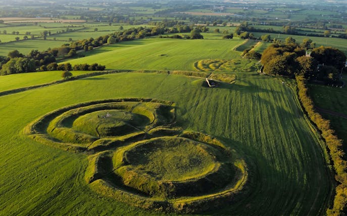 Aerial view of the Hill of Tara, Ireland, featuring ancient earthworks and lush green fields.