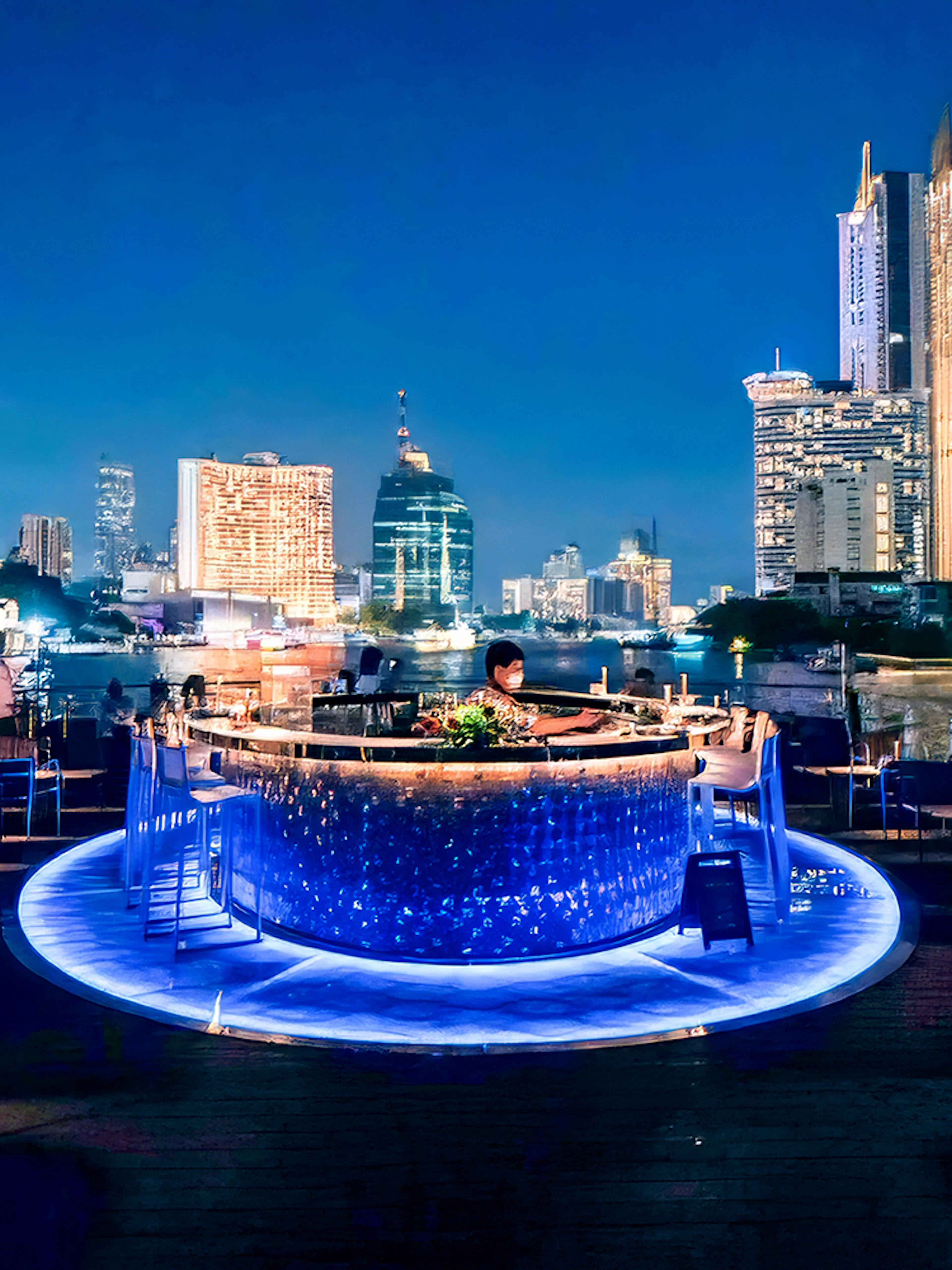 On-deck bar of the Saffron Luxury cruise with Bangkok skyline at night.