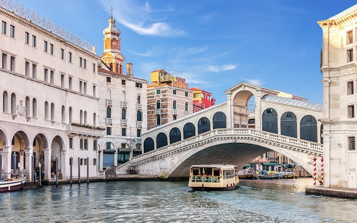 Rialto Bridge over Grand Canal with boat in Venice, Italy.