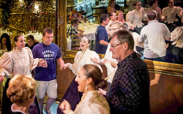 Guests enjoying a folklore dinner show at a traditional Maltese restaurant.