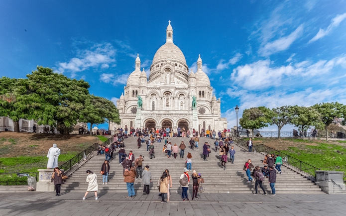 Basilica of the Sacred Heart with visitors on steps during Montmartre Train tour.