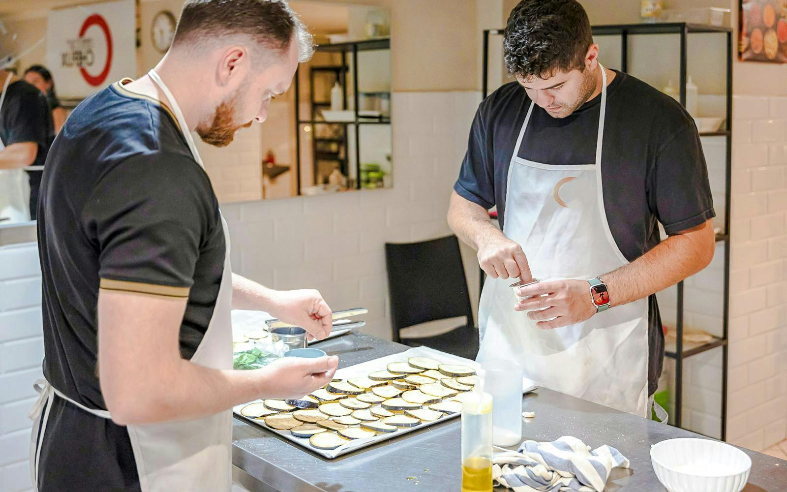 Participants preparing ingredients in a small group cooking class in Florence.