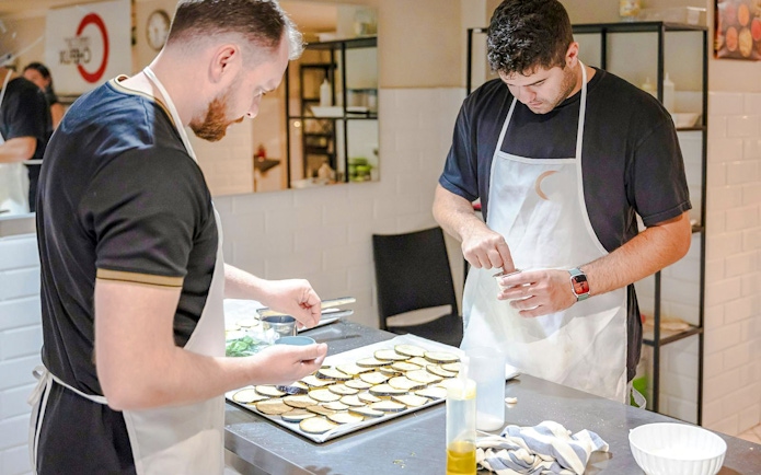 Participants preparing ingredients in a small group cooking class in Florence.