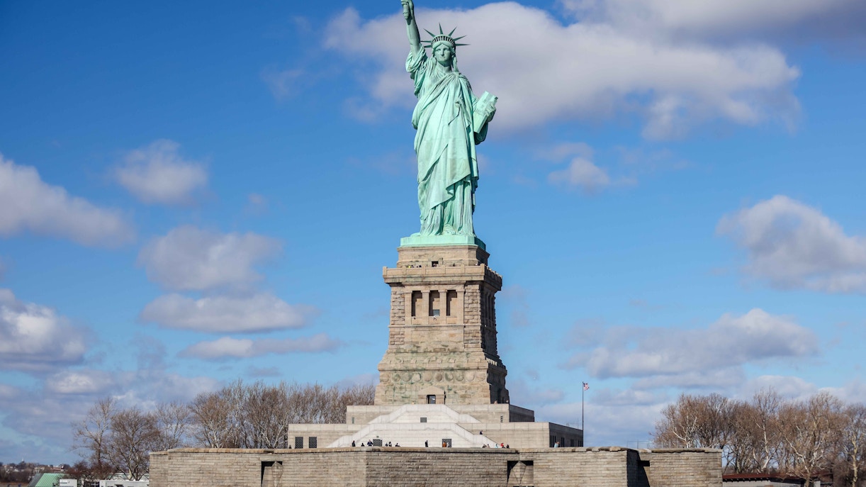 Statue of Liberty with New York City skyline in the background.