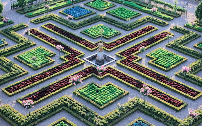 Maze Garden at Château of Villandry with geometric hedges and colorful flower beds.