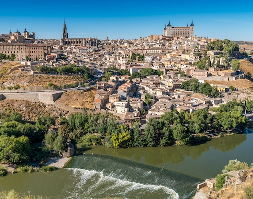 Aerial view of Toledo, Spain, featuring the Alcázar and the Tagus River.