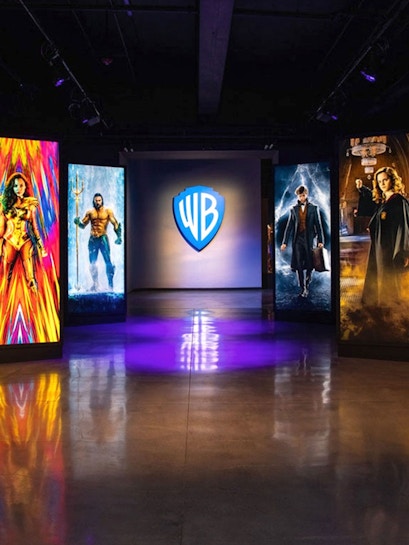 Warner Bros. Studio Tour Hollywood entrance with superhero and wizard displays.