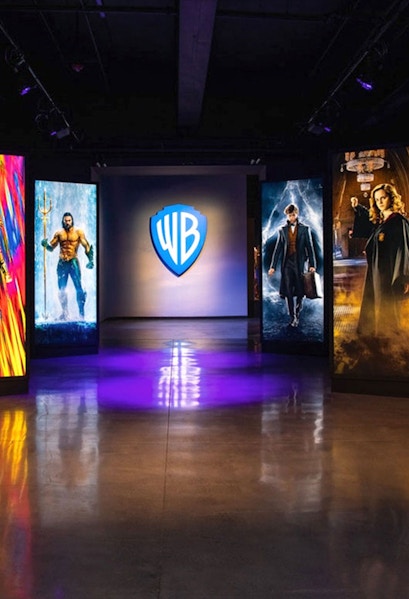Warner Bros. Studio Tour Hollywood entrance with superhero and wizard displays.