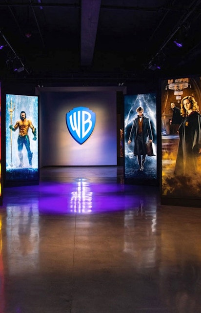 Warner Bros. Studio Tour Hollywood entrance with superhero and wizard displays.