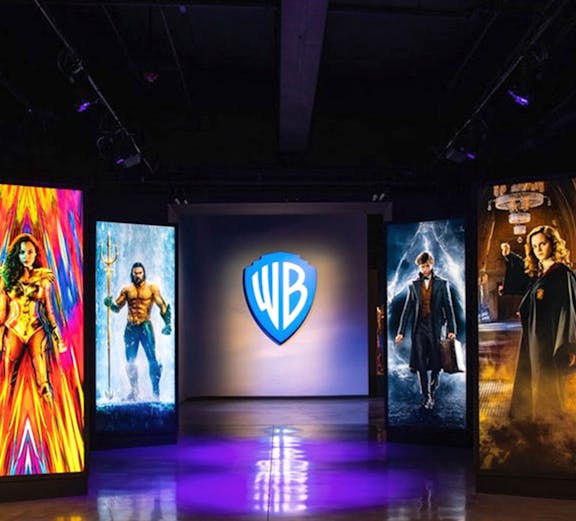 Warner Bros. Studio Tour Hollywood entrance with superhero and wizard displays.