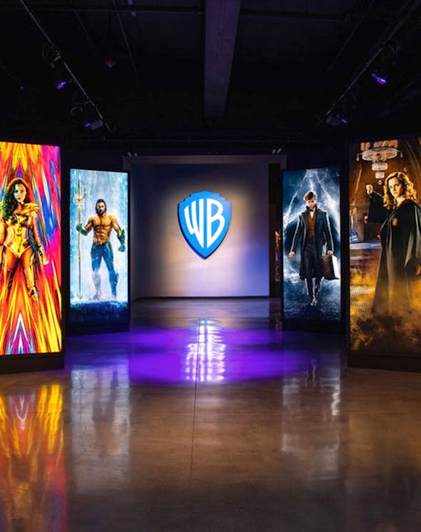 Warner Bros. Studio Tour Hollywood entrance with superhero and wizard displays.