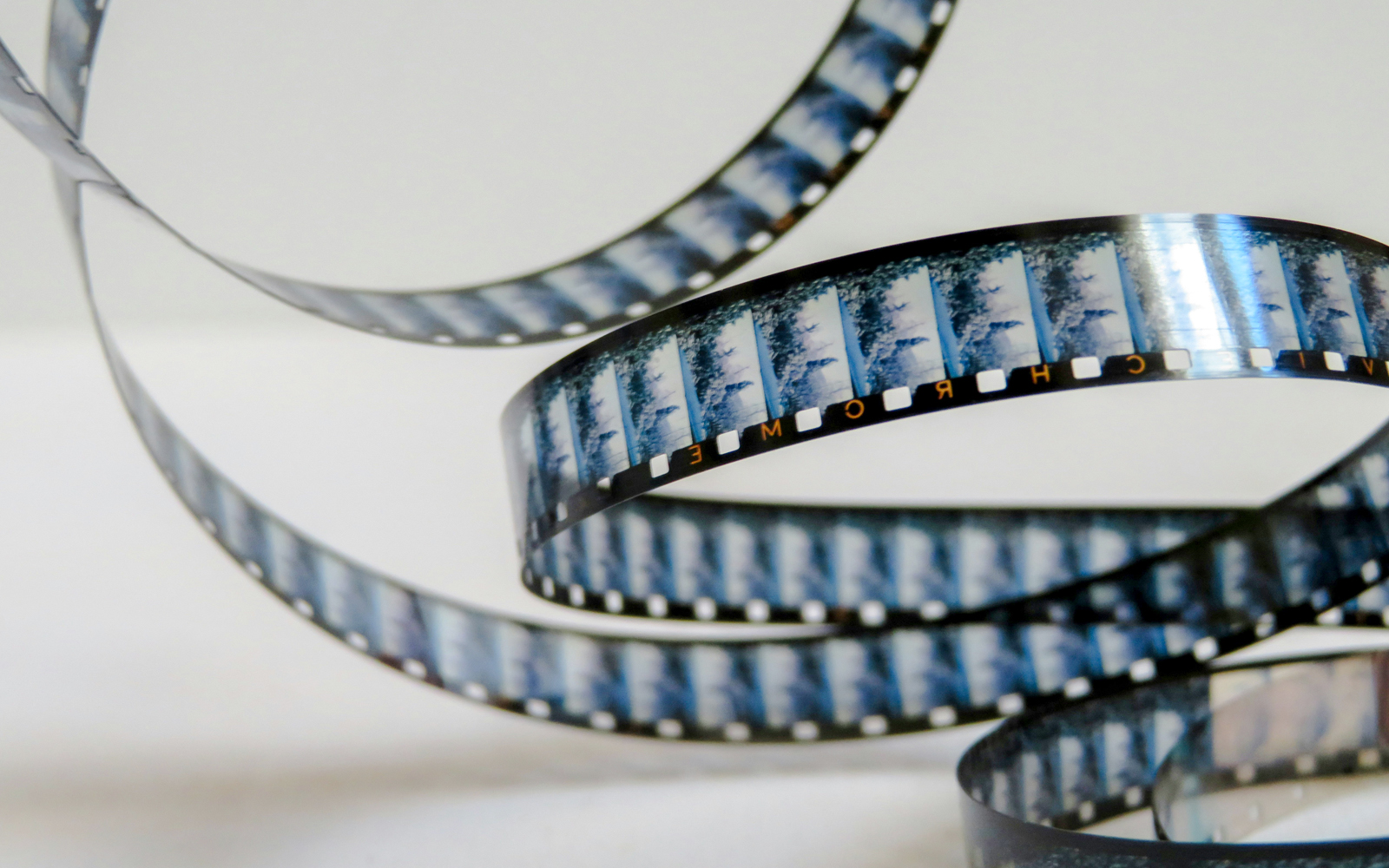 Film reel showcasing iconic movie scenes from global cinema tours.