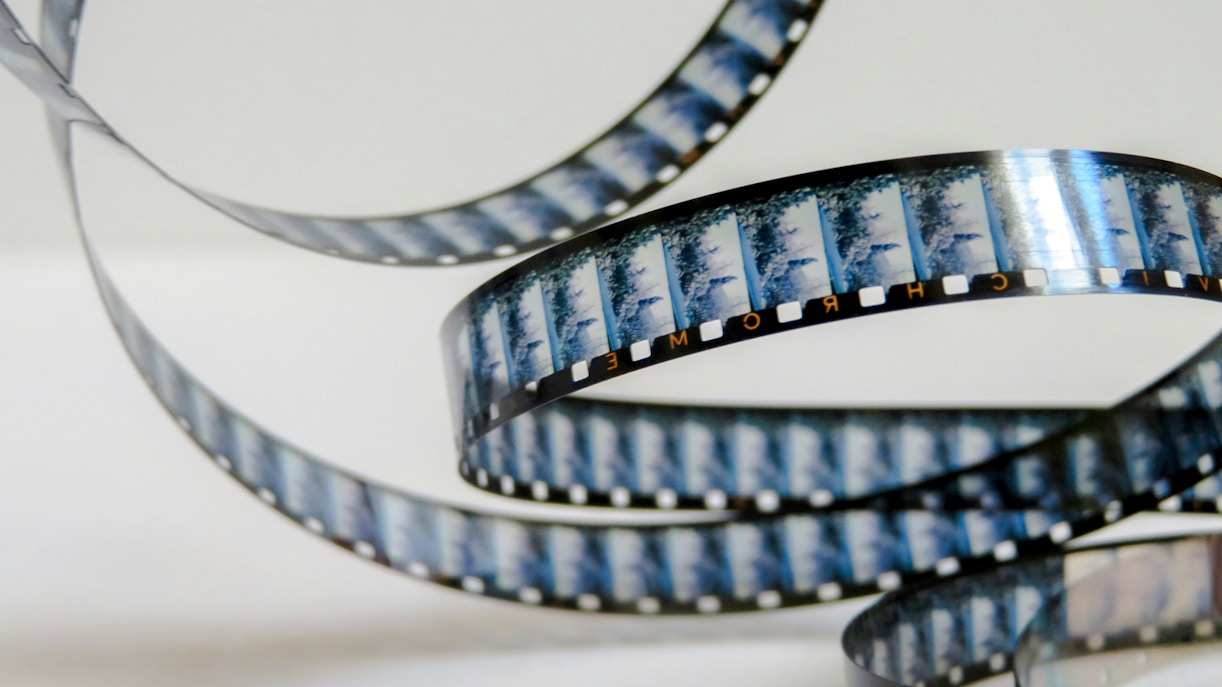 Film reel showcasing iconic movie scenes from global cinema tours.