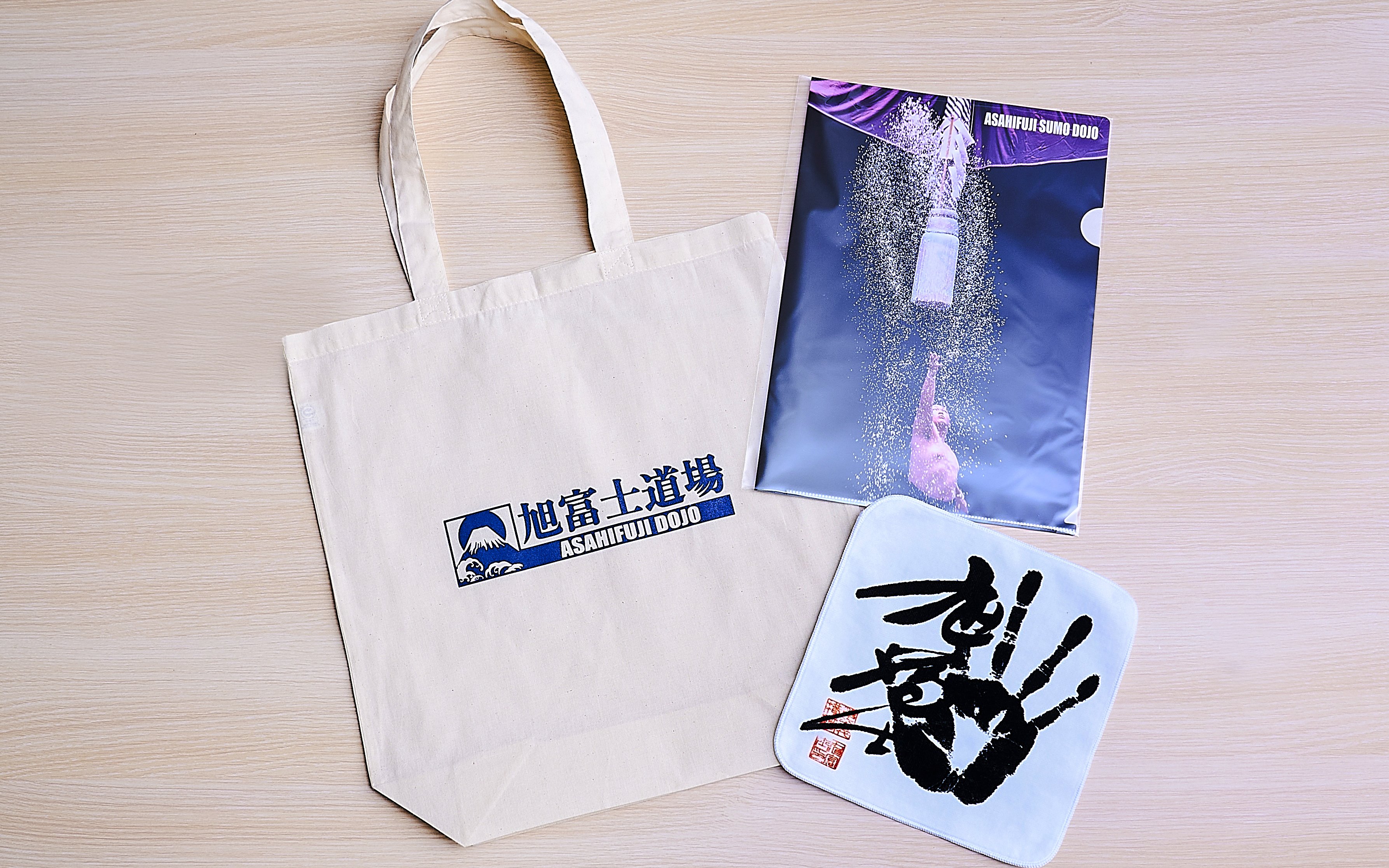 Koto City: Sumo show merchandise including tote bag and poster from Asahifuji Dojo.
