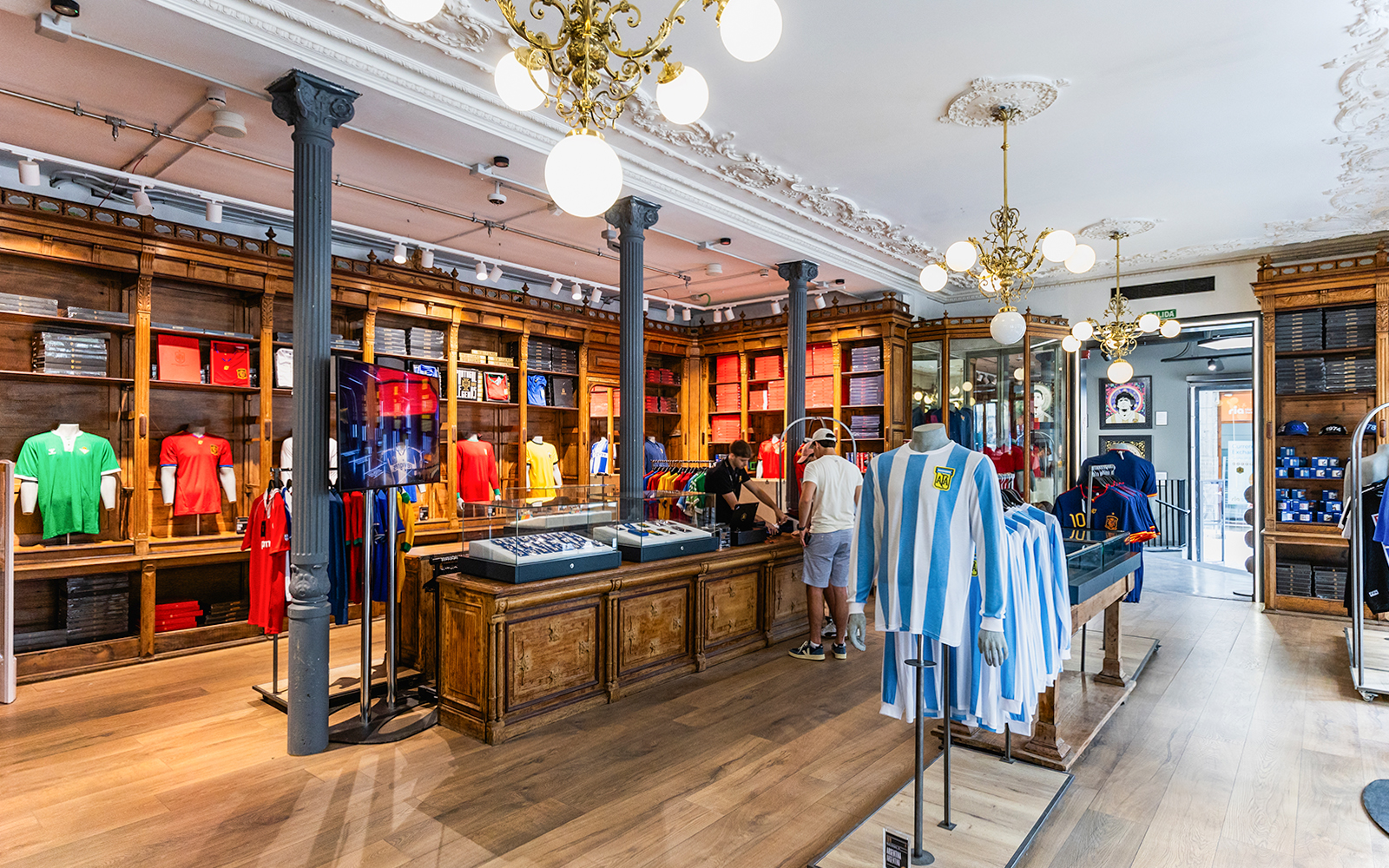 Visitors exploring the LEGENDS The Home of Football Store, showcasing a wide variety of football memorabilia and merchandise