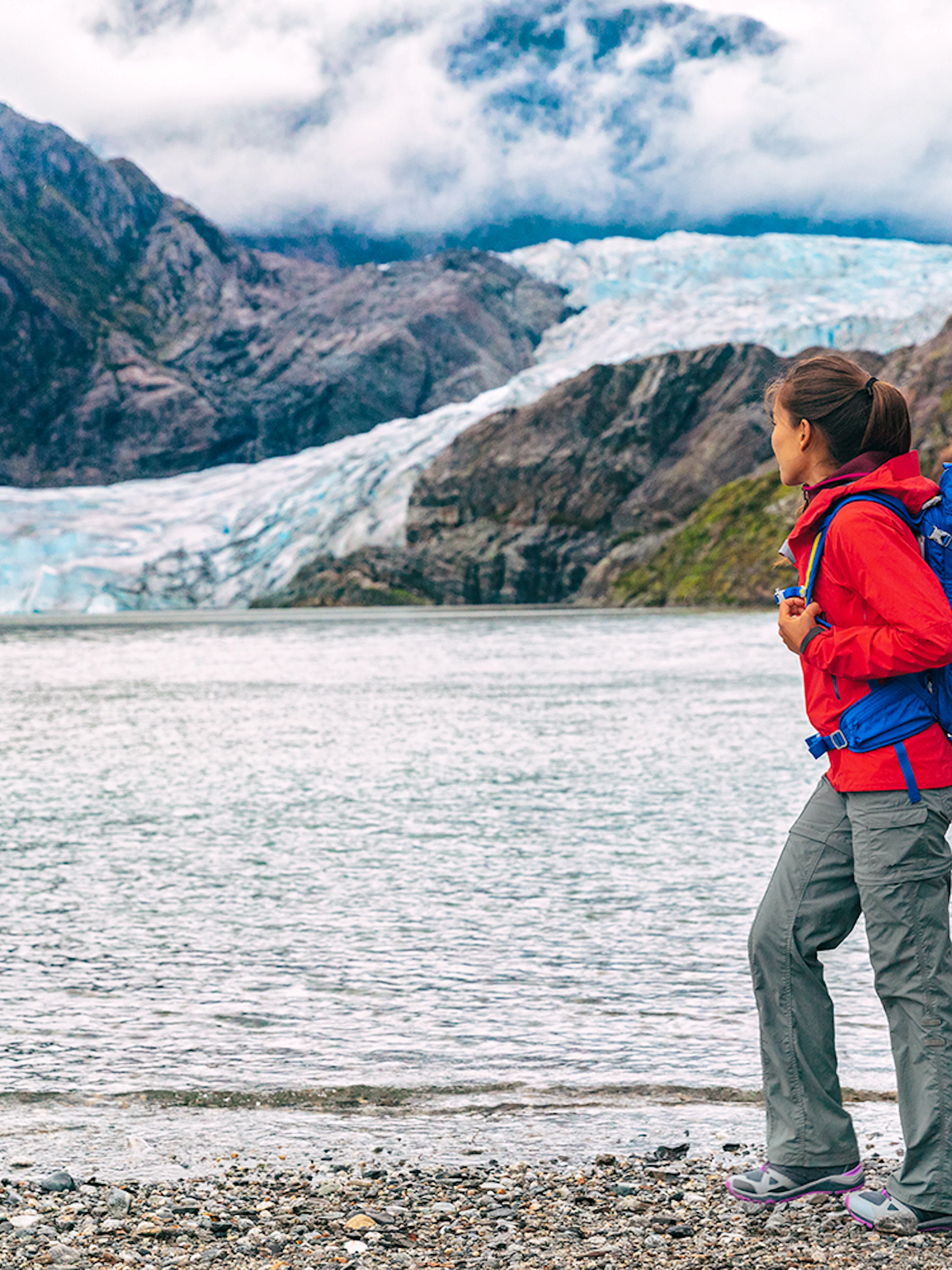 Traveler with backpack near Mendenhall Glacier in Juneau, Alaska.