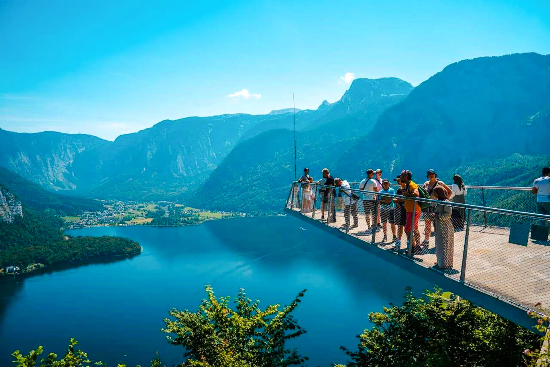 Visitors on Hallstatt Skywalk overlooking lake and mountains, part of Salzburg private tour.