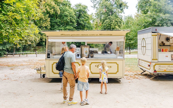 Family at an ice cream stand in the gardens of Chateau of Chantilly.