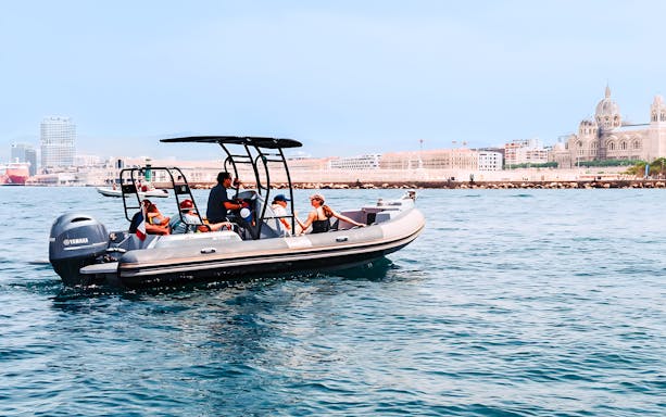 Boat tour in Marseille harbor with view of historic buildings and vibrant waterfront.