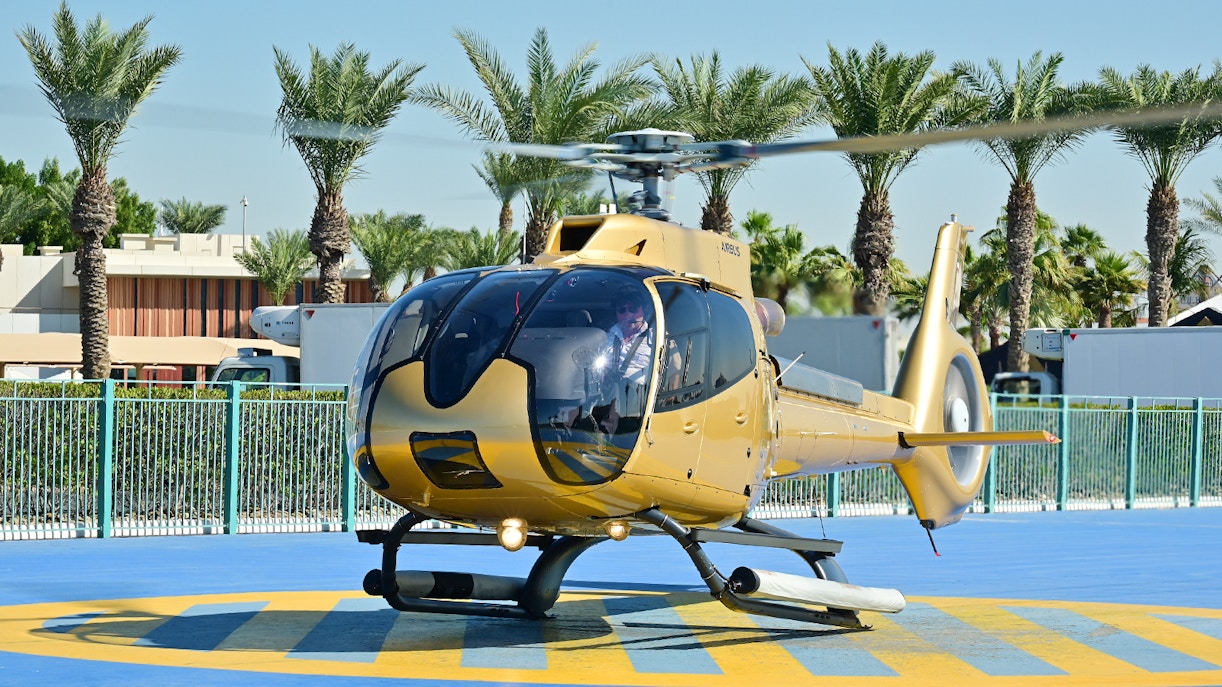 Helicopter on helipad ready for Dubai aerial tour.