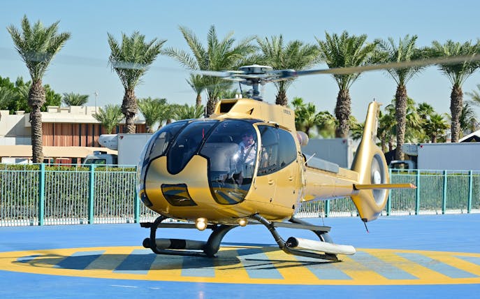 Helicopter on helipad ready for Dubai aerial tour.