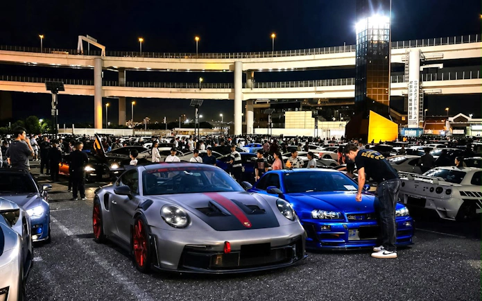 Car enthusiasts gather at Daikoku PA for Tokyo Drift JDM Culture Tour with Liberty Walk.