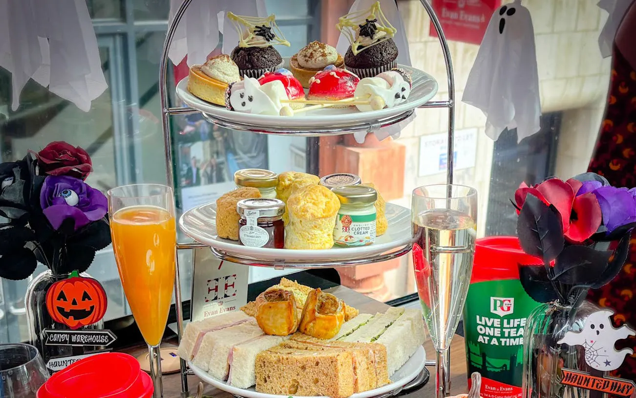 Halloween-themed afternoon tea with pastries and sandwiches on a London bus tour.