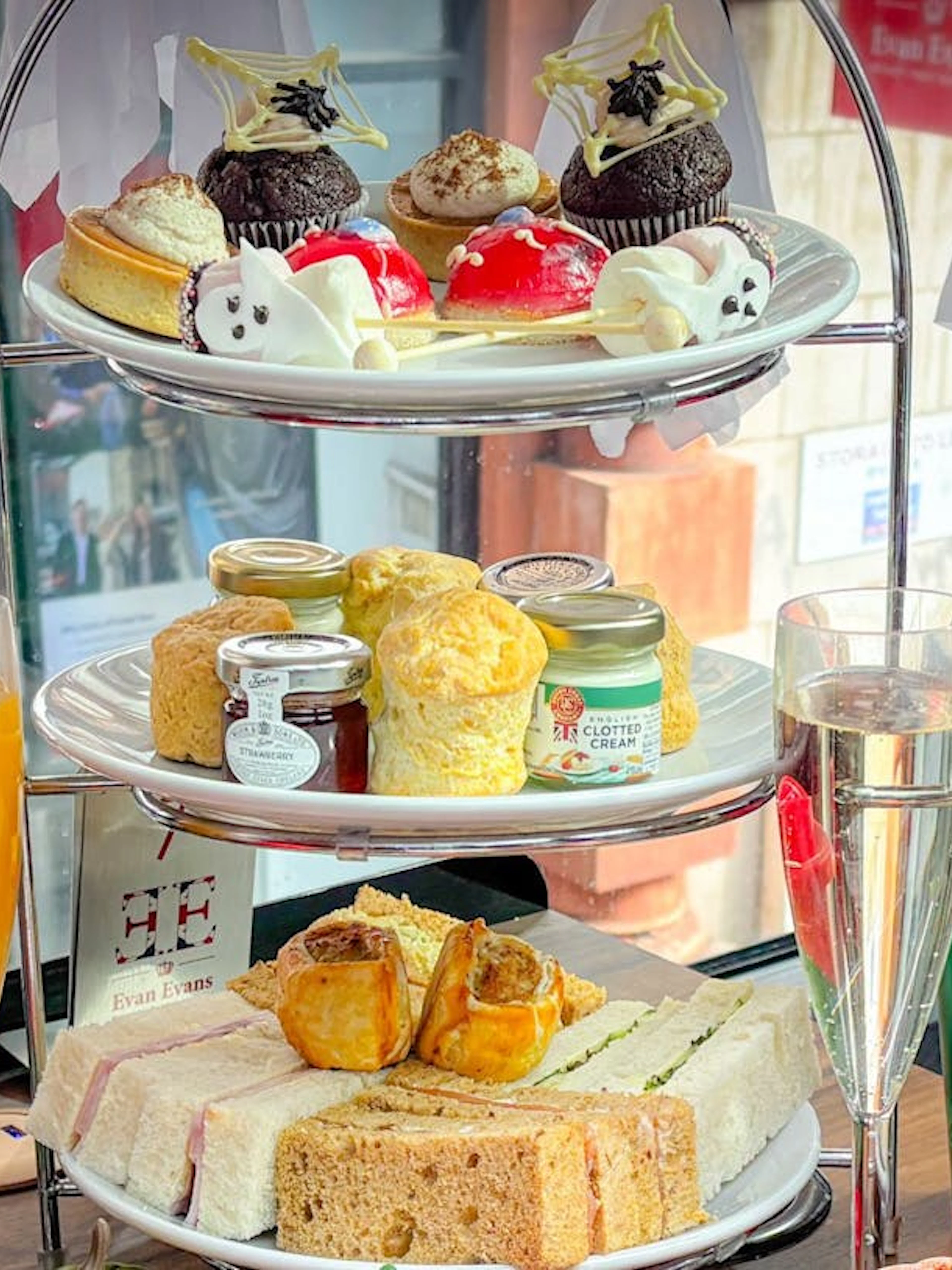 Halloween-themed afternoon tea with pastries and sandwiches on a London bus tour.