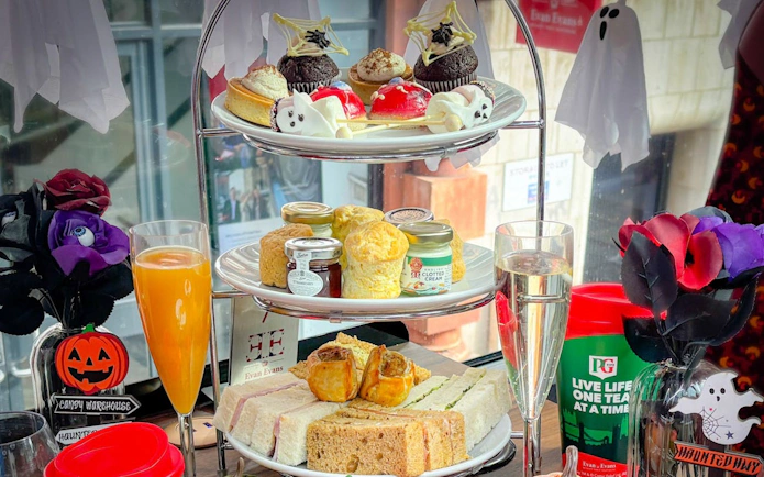 Halloween-themed afternoon tea with pastries and sandwiches on a London bus tour.