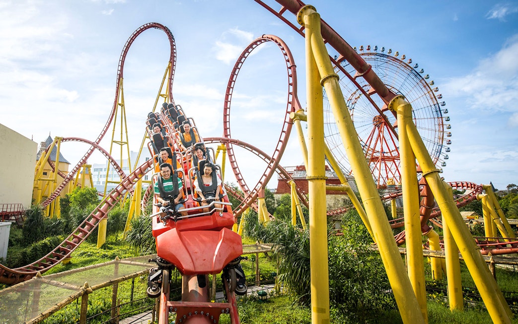 Roller coaster and Ferris wheel at VinWonders Phu Quoc theme park.