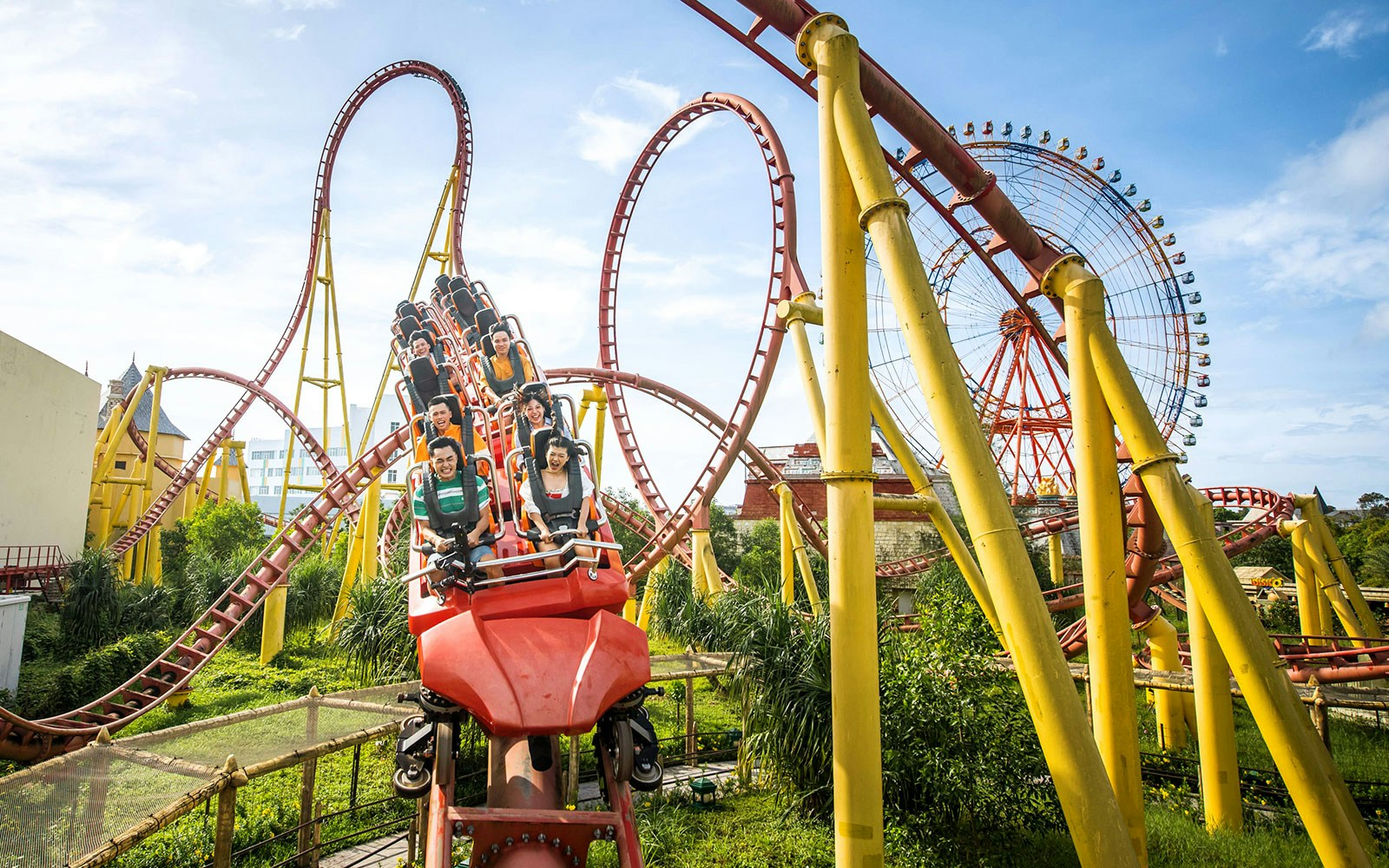 Roller coaster and Ferris wheel at VinWonders Phu Quoc theme park.