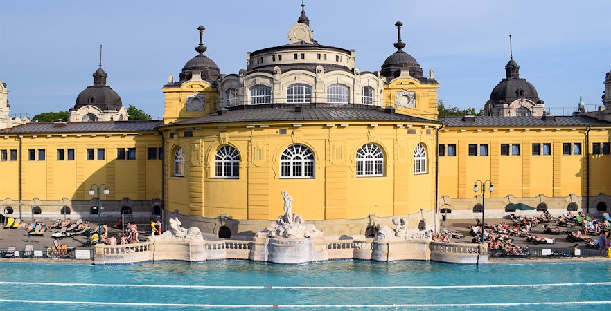 Széchenyi Thermal Bath in Budapest with people relaxing by the pool.