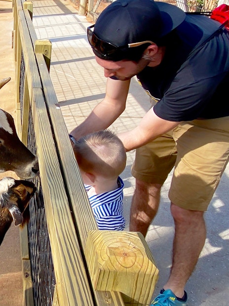 Man and child feeding goats at Gatorland petting zoo.