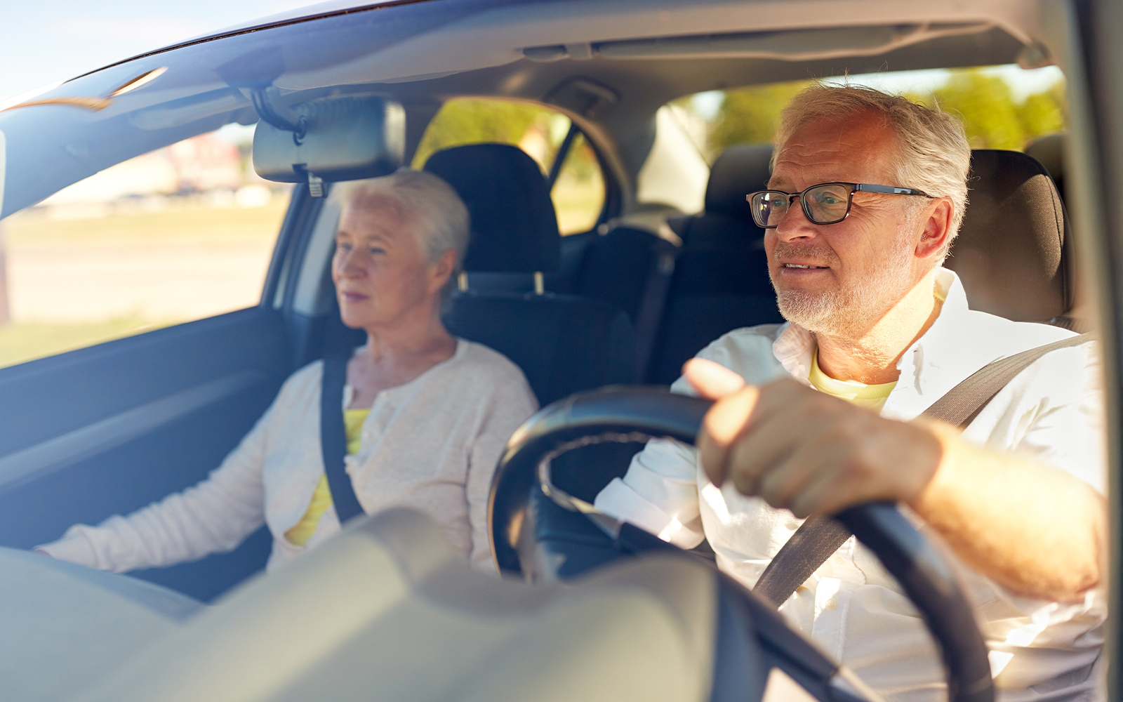 Senior couple in car driving