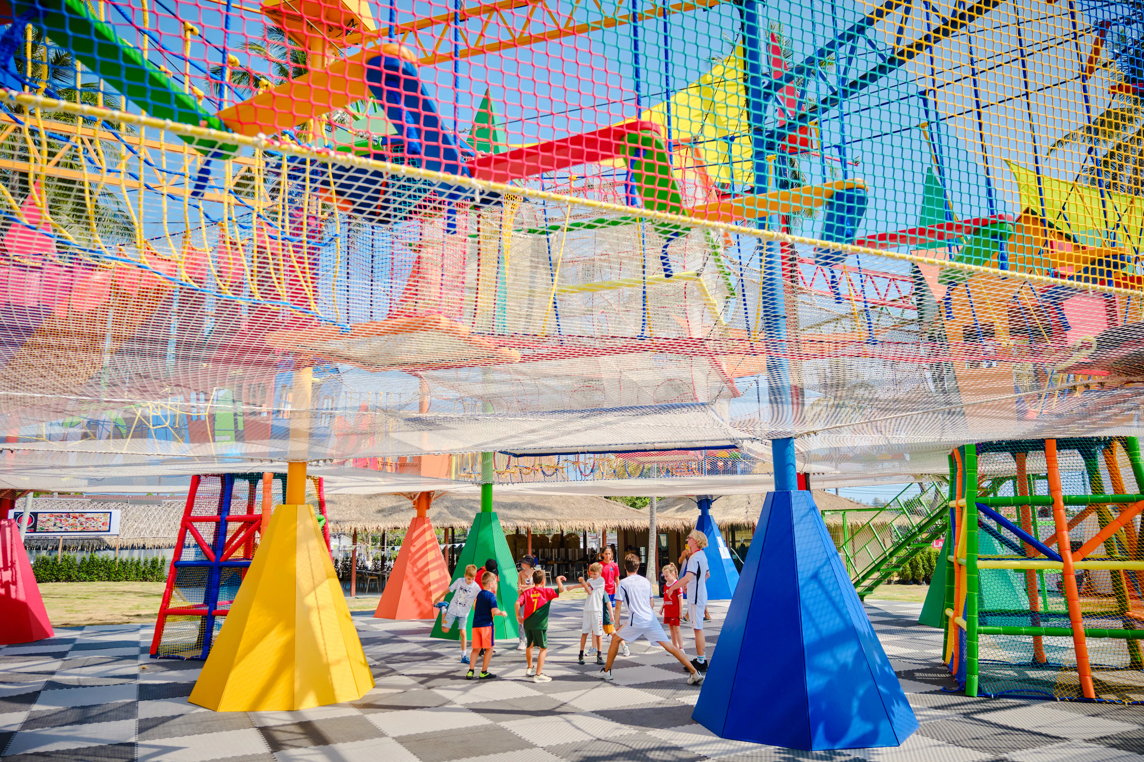 Children playing under colorful climbing nets at Ko Fun Kids Park, Phuket.