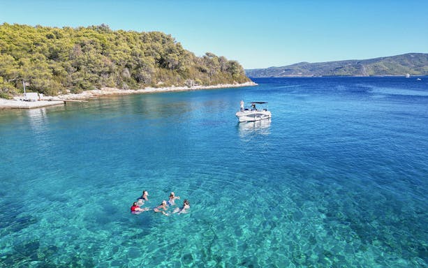 Group swimming near speedboat on North Shore of Hvar Island tour.
