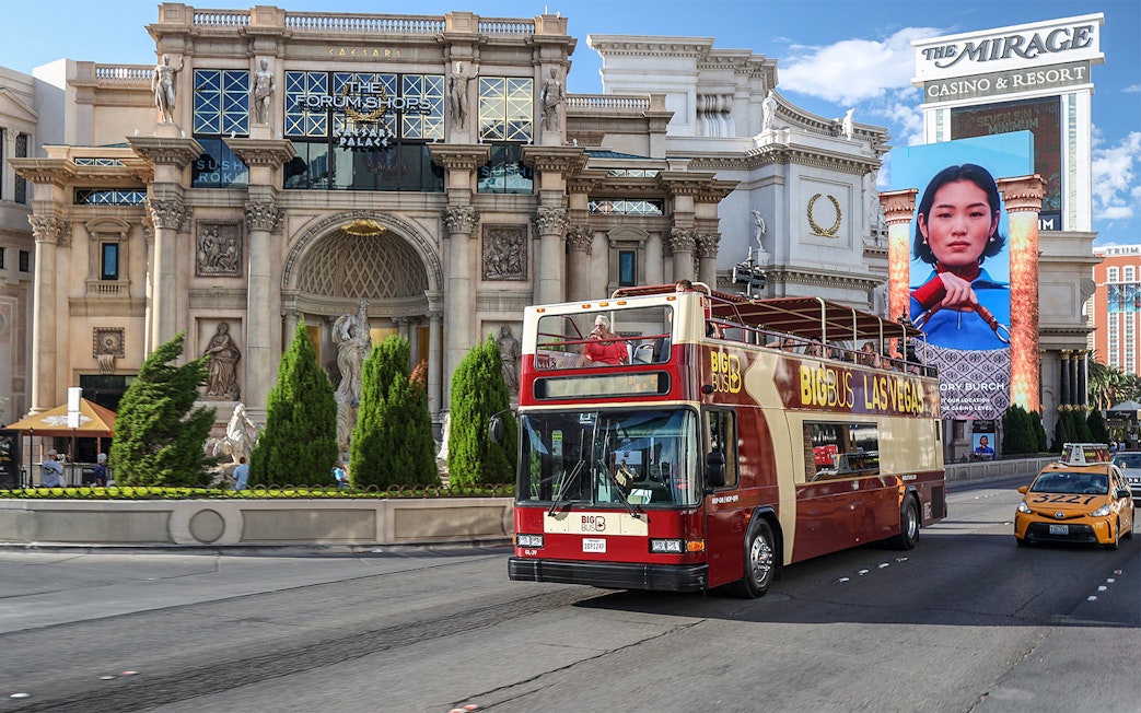 Big Bus tour passing Caesars Palace on Las Vegas Strip.