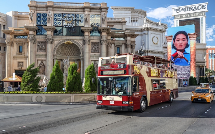 Big Bus tour passing Caesars Palace on Las Vegas Strip.